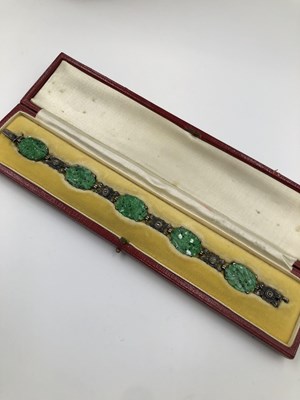 Lot 87 - A carved jade and marcasite bracelet in a...