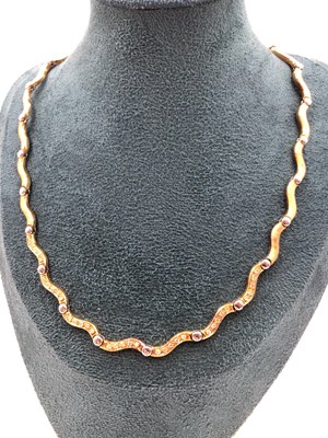 Lot 92 - A diamond set collar necklace. The wave links...
