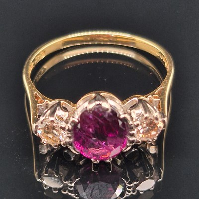 Lot 99 - An 18ct hallmarked gold purple sapphire and...