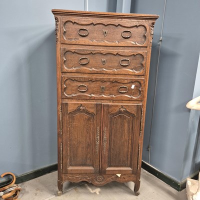 Lot 507 - A French oak cabinet with three shaped panel...