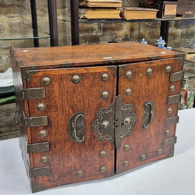 Lot 513 - A Chinese bronze bound hard wood cabinet, the...
