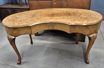 Lot 582 - A burr walnut kidney shaped writing table with...