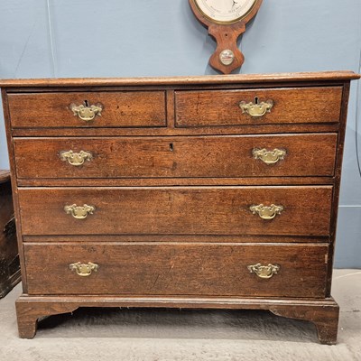 Lot 583 - A George III oak chest of two short and three...
