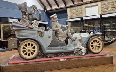 Lot 597 - A Lladro vintage car carrying parents and two...