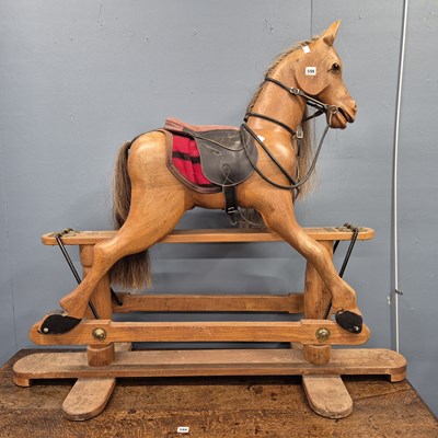 Lot 598 - A Robert Mullis saddled carved wood rocking...