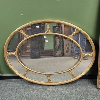 Lot 601 - An oval mirror, the gilt wood and gesso outer...