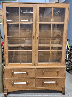 Lot 605 - A Cotswold school glazed oak display cabinet,...