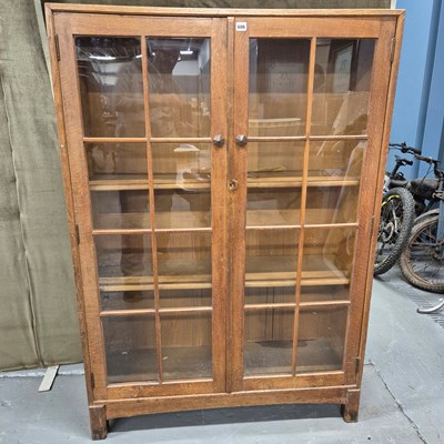 Lot 606 - A Cotswold school oak display cabinet,...