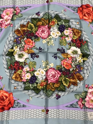 Lot 1107 - A vintage Gucci silk blue scarf with a flower...