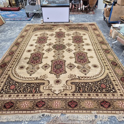 Lot 619 - A large machine made carpet of classic Persian...