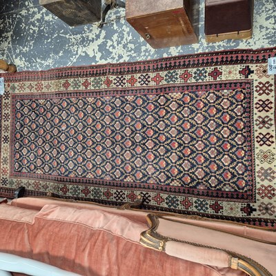 Lot 665 - An unusual antique caucasian rug. 200 x 96 cm.