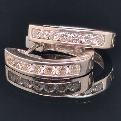 Lot 28a - A pair of white gold and channel set diamond...
