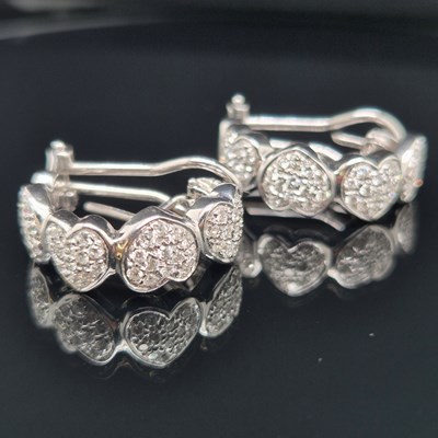 Lot 50a - A pair of diamond set half hoop multi-cluster...