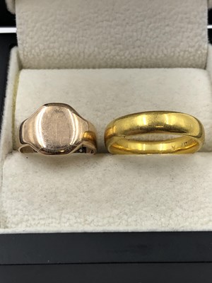 Lot 1047 - Two gold rings. A 22ct gold wedding ring, size...