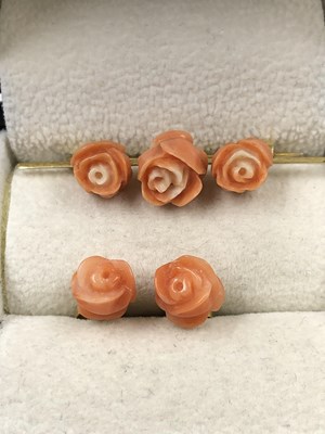 Lot 1019 - A vintage carved triple rose coral colour bar...