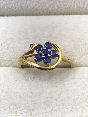 Lot 1029 - A blue gemset floral cluster ring, stamped 18c,...
