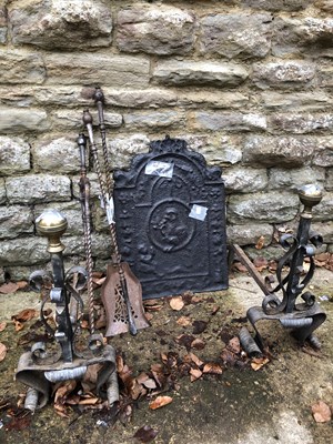 Lot 1258 - A Cast iron fire back, a pair of fire dogs and...
