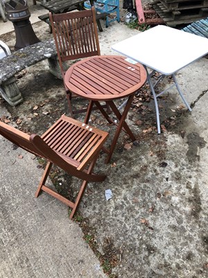 Lot 1274 - A teak patio table and two chairs together...