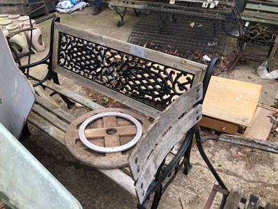 Lot 1295 - A garden bench with iron inset back.