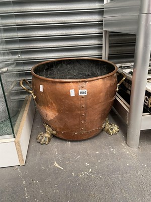 Lot 1540 - A brass handled copper wood basket on brass...