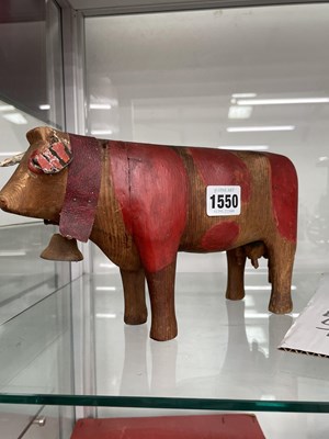 Lot 1550 - A carved wooden milch cow painted with red...