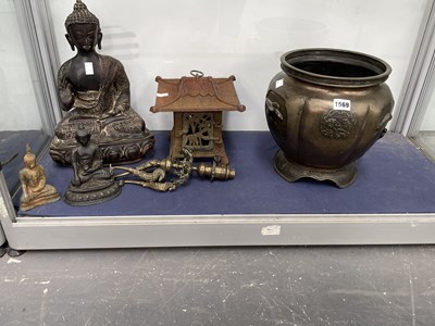 Lot 1569 - A bronze figure of the Buddha, two smaller, an...