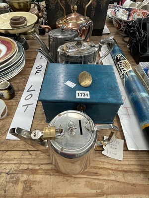 Lot 1731 - An electroplate tea pot money box, two other...