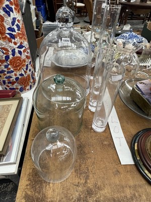 Lot 1806 - A graded set of three clear glass domes...