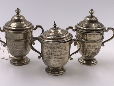 Lot 1057 - Three hallmarked silver presentation trophy...