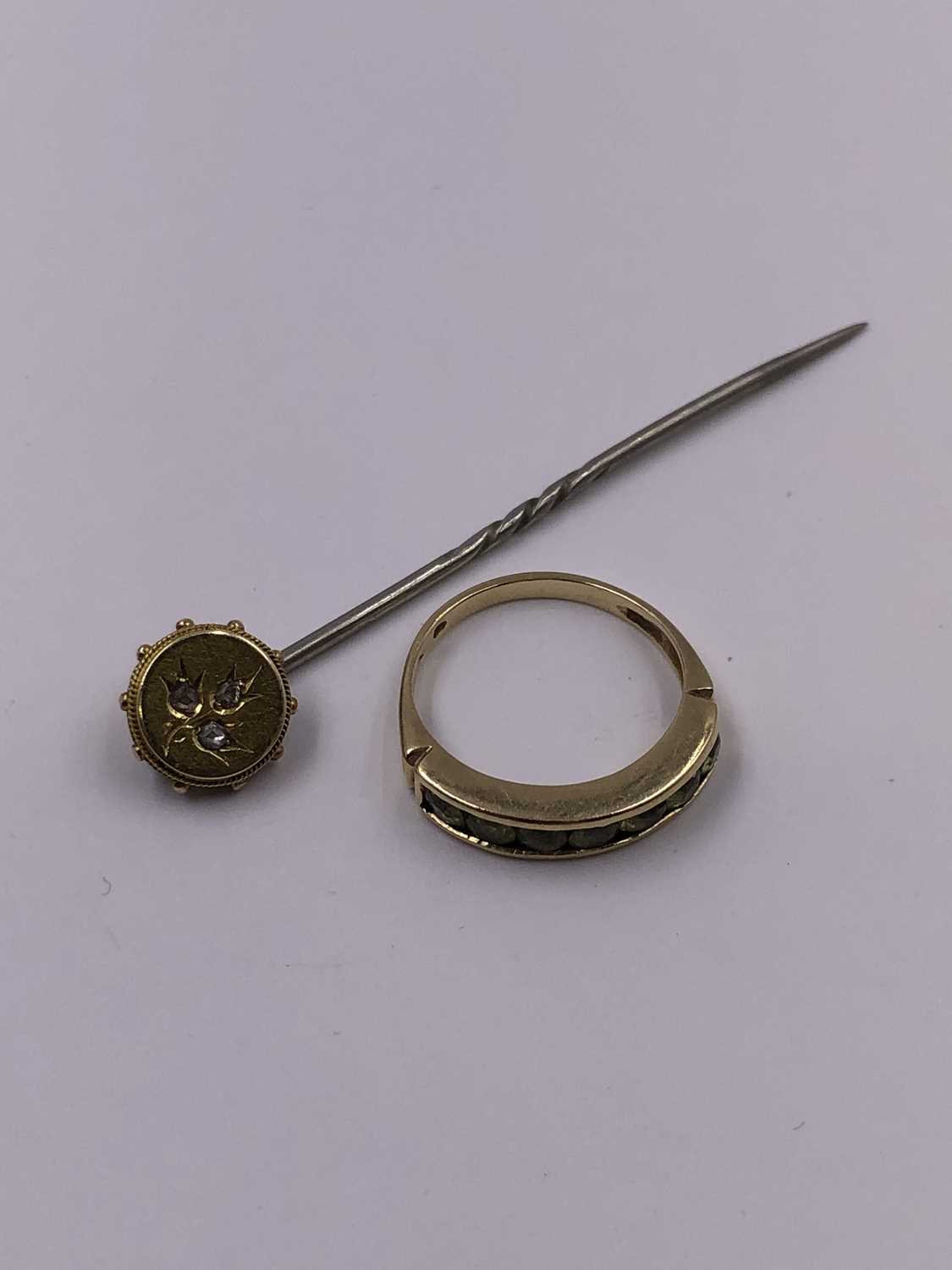 Lot 1015 - A 9ct hallmarked gold peridot channel set half...