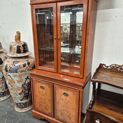 Lot 2225 - A modern two part display cabinet.
