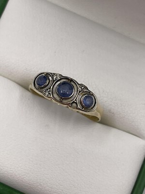 Lot 1059 - A vintage 18ct and platinum-stamped sapphire...