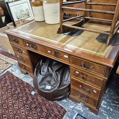 Lot 2269 - A twin pedestal desk with a leather top.
