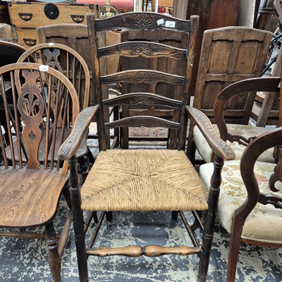 Lot 2281 - A 19th-century rush seat ladder back armchair.