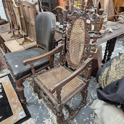 Lot 2299 - An 18th-century carved oak cane-backed armchair.