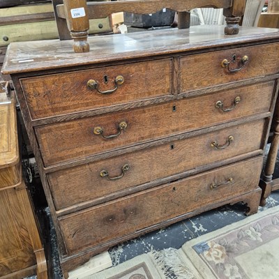 Lot 2307 - A Georgian oak chest of five drawers.
