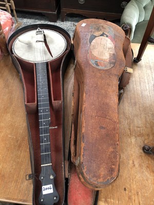 Lot 2006 - A cased banjo together with a leather mounted...