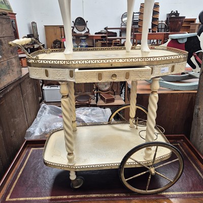 Lot 2322 - A retro cream and gilt drinks trolley.