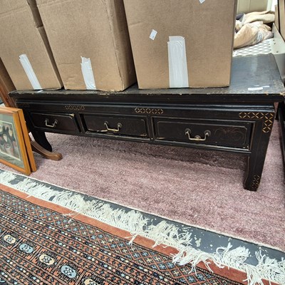 Lot 2377 - An oriental lacquered low table.