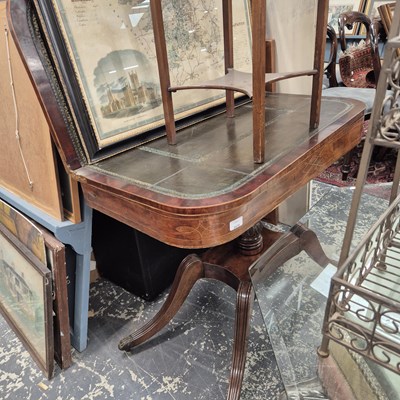 Lot 2419 - A regency mahogany fold-over card table.