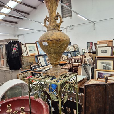 Lot 2431 - A wrought iron stand and a metal urn.