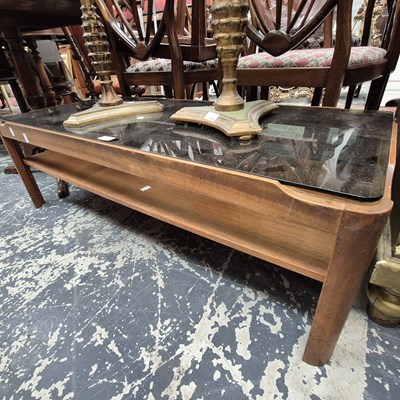 Lot 2539 - A retro teak and glass coffee table.