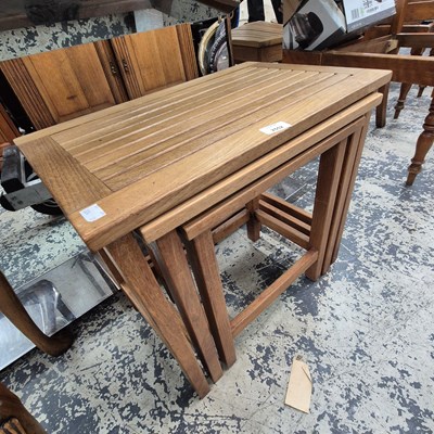 Lot 2552 - A teak nest of tables.