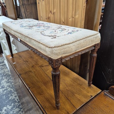 Lot 2647 - A long dressing stool with a needlepoint top.