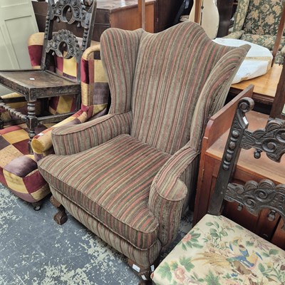 Lot 2657 - A Georgian-style wingback armchair.