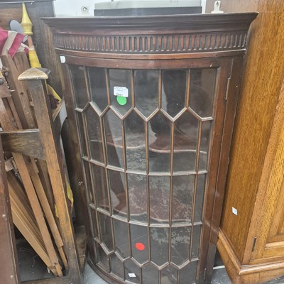 Lot 2691 - A bow-front corner cabinet.