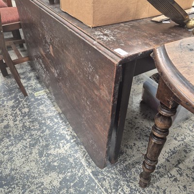 Lot 2747 - A large Georgian mahogany drop-leaf table.