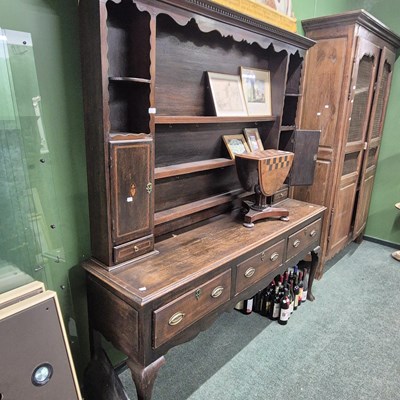 Lot 2769 - A Georgian country oak three-drawer dresser.