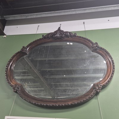 Lot 2788 - A large mahogany-framed shaped wall mirror.