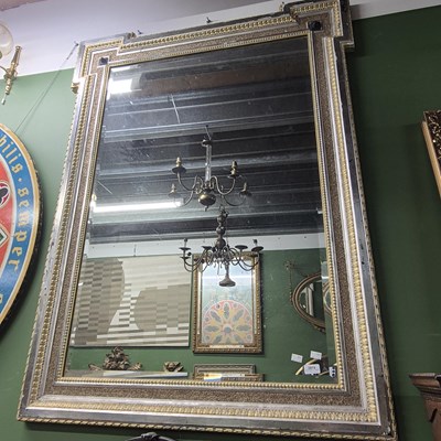 Lot 2819 - A large mirror with a stepped top frame.